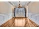 Bright dining room with hardwood floors, wainscoting, and large window at 6926 Linkside Ct, Charlotte, NC 28277