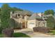 Charming two-story home featuring a well-manicured lawn, brick exterior, and attached two-car garage at 6926 Linkside Ct, Charlotte, NC 28277
