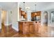 Kitchen with island, hardwood floors, and wooden cabinets at 6926 Linkside Ct, Charlotte, NC 28277