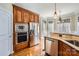 Kitchen boasts stainless steel appliances and wood cabinetry at 6926 Linkside Ct, Charlotte, NC 28277