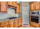 Kitchen with granite countertops, gas cooktop, and wood cabinets at 6926 Linkside Ct, Charlotte, NC 28277