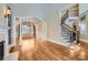 Two-story living room with hardwood floors, fireplace and staircase at 6926 Linkside Ct, Charlotte, NC 28277