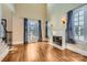 Spacious living room with hardwood floors, fireplace and large windows at 6926 Linkside Ct, Charlotte, NC 28277