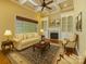 Cozy living room with coffered ceiling, fireplace, built-in bookshelves, and plush seating at 6926 Linkside Ct, Charlotte, NC 28277