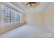 Main bedroom with high ceilings, large window, and carpet at 6926 Linkside Ct, Charlotte, NC 28277