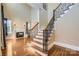 Elegant staircase with wrought iron railing and hardwood floors at 6926 Linkside Ct, Charlotte, NC 28277