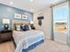 Bright bedroom with blue accent wall, comfortable bed and window seat at 841 Blue Canyon Dr, York, SC 29745