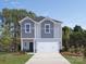 Two-story house with gray and white siding, a white garage door, and a landscaped lawn at 841 Blue Canyon Dr, York, SC 29745