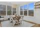 Bright dining room with a farmhouse table and large windows at 8788 Potter Rd, Matthews, NC 28104