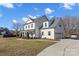 Two-story farmhouse features a charming front porch and attached garage at 8788 Potter Rd, Matthews, NC 28104