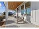 Relaxing front porch with rocking chairs and a wooden ceiling at 8788 Potter Rd, Matthews, NC 28104