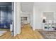 Light-filled hallway showcasing hardwood floors and access to other rooms at 8788 Potter Rd, Matthews, NC 28104