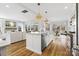 Open concept kitchen with island, stainless steel appliances, and hardwood floors at 8788 Potter Rd, Matthews, NC 28104