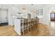 Modern kitchen with white cabinetry, marble countertops, and an island at 8788 Potter Rd, Matthews, NC 28104