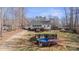 Sprawling backyard featuring a deck, pool, wooded scenery, and back of the house at 888 Brevard Place Rd, Iron Station, NC 28080
