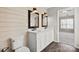 Bright bathroom features a double sink vanity with white cabinets, framed mirrors, and wood-look flooring at 888 Brevard Place Rd, Iron Station, NC 28080