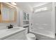 Bright bathroom features a single sink vanity with white cabinets, framed mirror, and tub with shower at 888 Brevard Place Rd, Iron Station, NC 28080