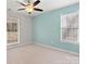 This spacious bedroom features neutral carpet, two windows, and ceiling fan at 888 Brevard Place Rd, Iron Station, NC 28080