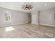 Large bonus room with plenty of natural light and neutral paint at 888 Brevard Place Rd, Iron Station, NC 28080