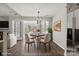 Cozy dining area features wood floors, round table with seating for four, and natural light at 888 Brevard Place Rd, Iron Station, NC 28080