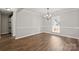 Bright dining room featuring wood floors, crown molding, chair rails, and a stylish chandelier at 888 Brevard Place Rd, Iron Station, NC 28080
