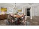 This dining room features a wood table, chairs, area rug, and light fixture at 888 Brevard Place Rd, Iron Station, NC 28080