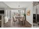Dining room with hardwood floors, and double doors leading to a sunroom, tastefully decorated at 888 Brevard Place Rd, Iron Station, NC 28080