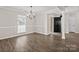 The dining room with a hanging light fixture features light walls and wood-look flooring at 888 Brevard Place Rd, Iron Station, NC 28080