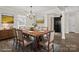 Staged dining room features neutral decor, stylish chandelier and an area rug beneath the dining table at 888 Brevard Place Rd, Iron Station, NC 28080