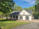 Charming exterior view of a single-Gathering home with a manicured lawn and a covered porch at 888 Brevard Place Rd, Iron Station, NC 28080