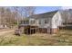 Home's exterior with a sunroom, deck, and access stairs, offering a blend of indoor-outdoor living at 888 Brevard Place Rd, Iron Station, NC 28080