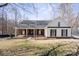 Charming ranch-style home featuring a covered front porch, black shutters, and a manicured lawn at 888 Brevard Place Rd, Iron Station, NC 28080