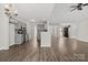 This open-concept kitchen features stainless steel appliances, gray cabinets, and wood-look flooring at 888 Brevard Place Rd, Iron Station, NC 28080