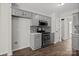 The gray kitchen features stainless steel appliances, gray cabinets, and access to a hallway at 888 Brevard Place Rd, Iron Station, NC 28080