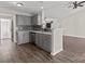 Open-concept kitchen boasts stainless steel appliances, breakfast bar and gray cabinetry at 888 Brevard Place Rd, Iron Station, NC 28080
