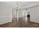 An open concept living room with wood-look flooring has a fireplace and high ceilings at 888 Brevard Place Rd, Iron Station, NC 28080