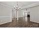 Spacious living room with modern lighting, wood floors, neutral paint and a fireplace at 888 Brevard Place Rd, Iron Station, NC 28080