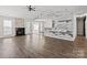 Spacious living room with a fireplace, shiplap accent wall, and wood-look flooring at 888 Brevard Place Rd, Iron Station, NC 28080