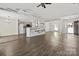 Open-concept living room with views into kitchen, hardwood floors, and modern finishes at 888 Brevard Place Rd, Iron Station, NC 28080