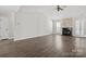 This living room has high ceilings, a fireplace, wood-look floors, and natural light at 888 Brevard Place Rd, Iron Station, NC 28080