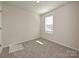 Well-lit bedroom featuring neutral walls and carpeted floors at 909 Smithcliffs Trl, York, SC 29745