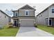 Two-story house with gray siding, two-car garage, and landscaping at 909 Smithcliffs Trl, York, SC 29745