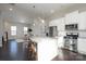 Modern kitchen with white cabinets, granite countertops, stainless steel appliances, and breakfast bar at 9115 Bluefield St, Charlotte, NC 28273