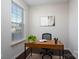 Home office with wood desk, window, and neutral decor at 9115 Bluefield St, Charlotte, NC 28273