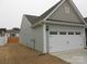 House exterior showcasing a two-car garage and side yard at 106 Milliner Dr # 97, Troutman, NC 28166