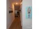 Long hallway with light wood floors and wall art at 106 Milliner Dr # 97, Troutman, NC 28166