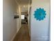 Hallway view featuring modern artwork and decorative flower leading to the living area at 106 Milliner Dr # 97, Troutman, NC 28166