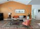 Cozy living room with a high ceiling, a comfortable sectional couch, and striking orange accent wall at 106 Milliner Dr # 97, Troutman, NC 28166