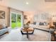 Living room with light-colored sofa, wooden coffee table, and sliding door at 11027 Daisy Ct, Charlotte, NC 28262