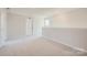 Large bonus room with soft carpeting, a half wall, and a bright window at 1171 Blackburn Cir, Edgemoor, SC 29712